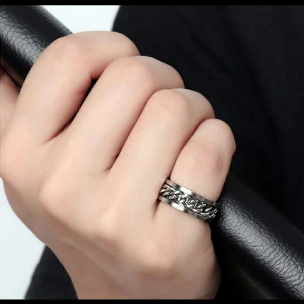 Silver Tone Ring with a Chain Around It